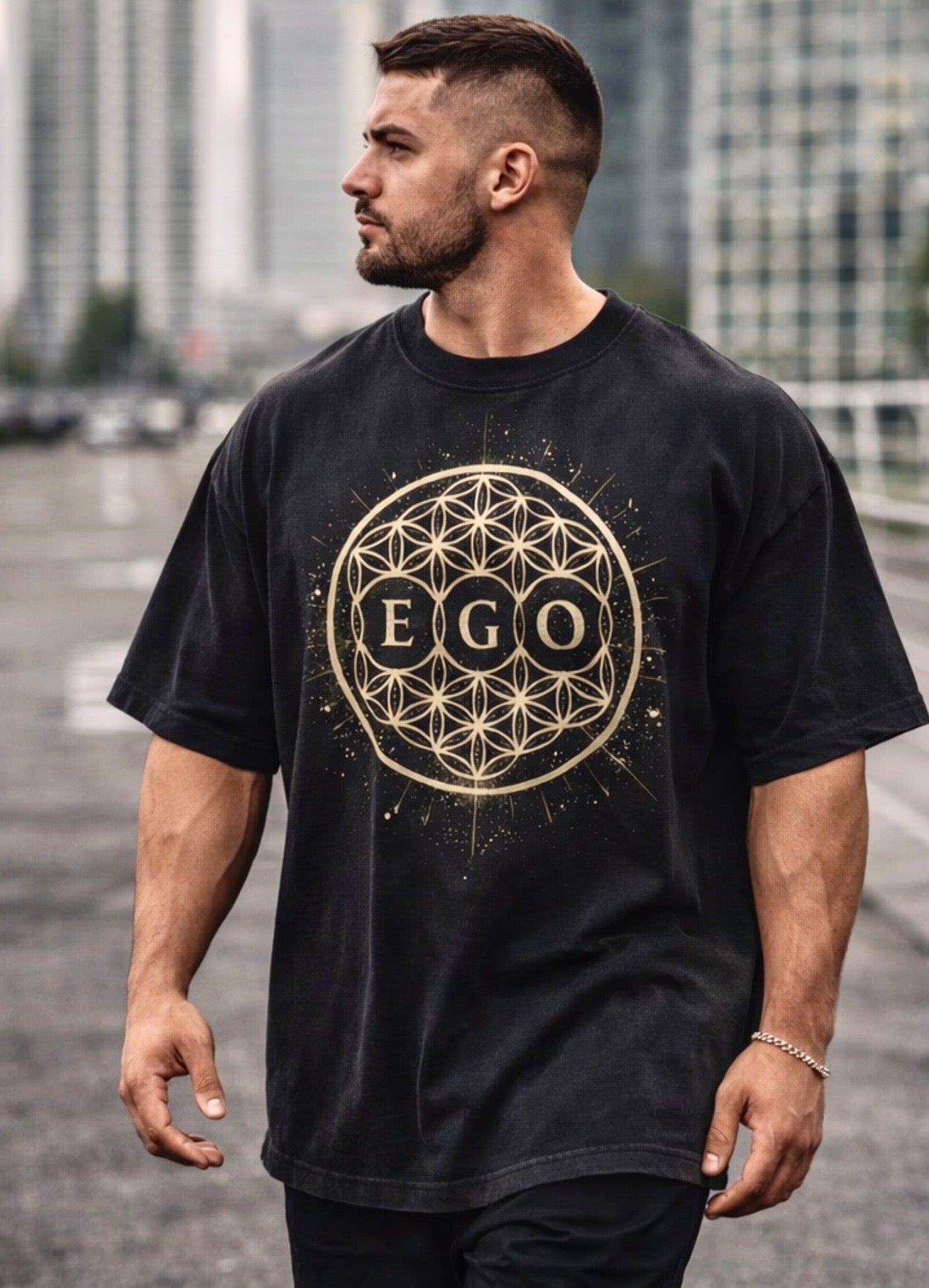 Man wearing a black t-shirt with 'EGO' design in a city setting